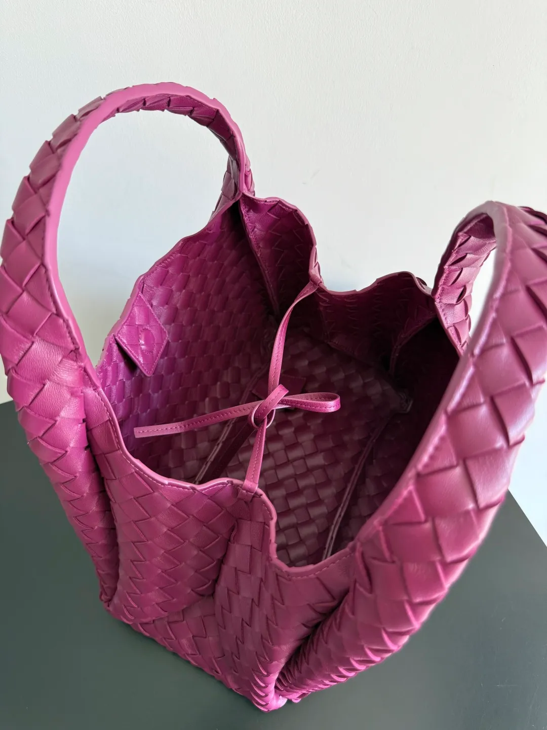 Batch 2160 new products are coming! BOTTEGA VENETA Bottega Veneta's 2025 new Campana shoulder bag is on the market~ First of all, I would like to praise the weight of this bag. As a not too small bag, it is very light for daily use. For people like me who need to carry a lot of belongings when going out, this advantage is great, and it greatly reduces the burden of traveling. 🛍️The shape is a bit like a combination of parachute and jodie. The blunt triangle shape is cute and honest. Carrying it on your back when going shopping is a good mood accelerator. The handles and body of the bag are both classic weaves. A tie is added to the original open design. If it is not tied up, the bag will look like a small vegetable basket when carried. Style number: 844249 Size: 33*20*16.5cm